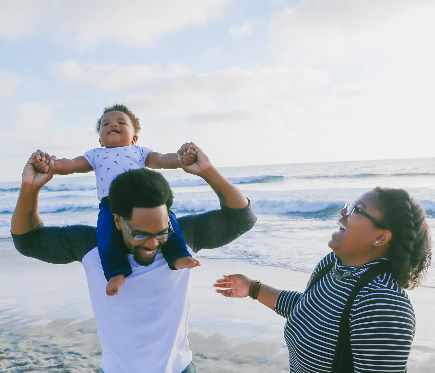 A young family enjoying a sunny day at the beach together