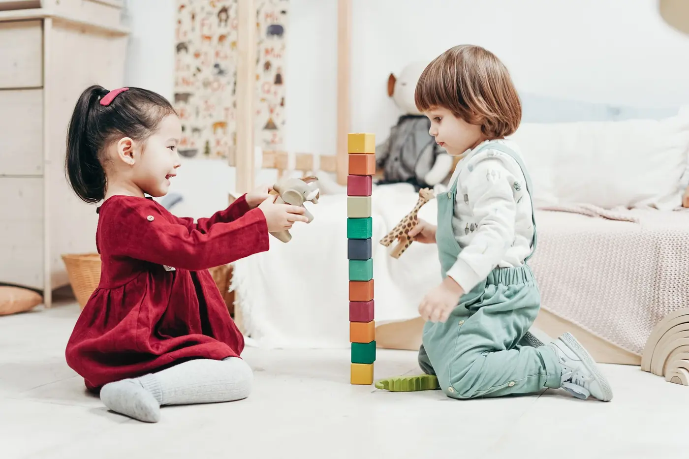Two toddlers playing side by side at playgroup