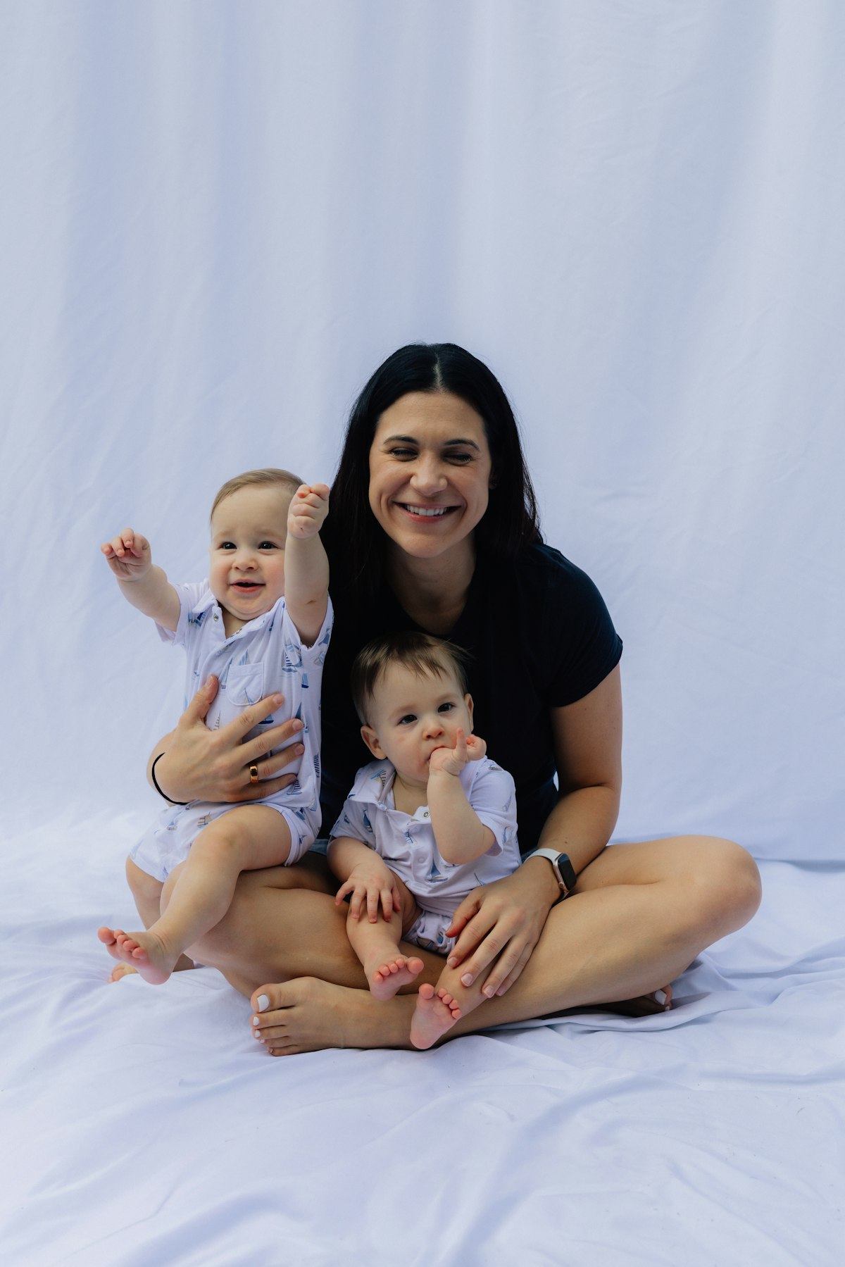 A mother holding her two babies